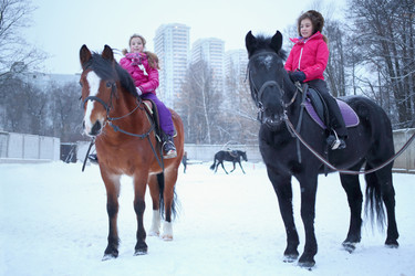Two girls sitting on horseback at the equestrian - paha_l