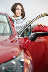 Beautiful girl in a fur leaving the red car in the - paha_l
