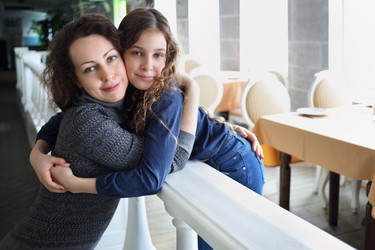 Happy mother and her daughter embrace in - paha_l
