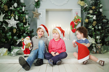 Two boys and little girl sit on floor near - paha_l