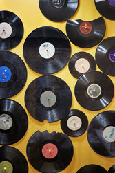 Old dusty damaged vinyl disks pinned tothe yellow - paha_l