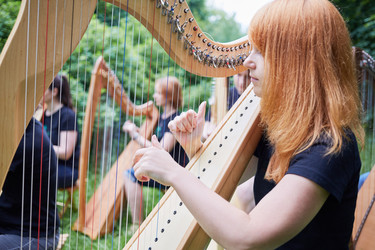 Musicians play harps outdoors in park - paha_l