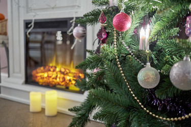 Decorated Christmas firtree near fireplace in room - paha_l