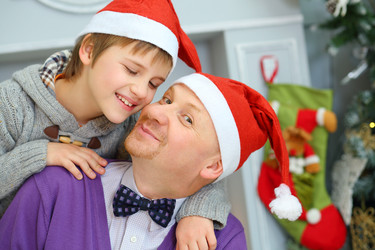 Father with his son in santa caps pose near - paha_l