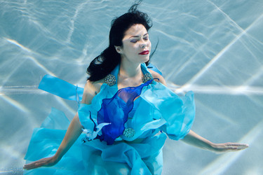 Young black-haired smiling woman in blue dress - paha_l