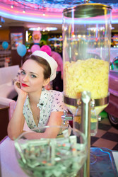 Young woman in retro dress sitting in bar with - paha_l