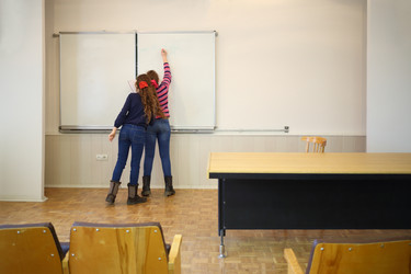 Schoolgirls write on blackboard geometry example - paha_l