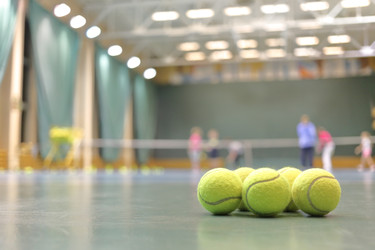 Some tennis balls on tennis court in sports hall, - paha_l