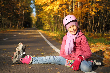 Happy girl in a protective helmet sits - paha_l