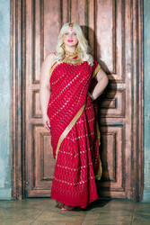 Blonde woman in red dress stands her back to - paha_l