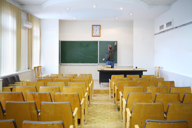 Teacher clears with blackboard in empty classroom, - paha_l