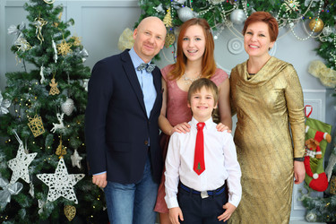 Happy mother, father and two children pose in room - paha_l
