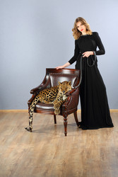 Leopard in chair and pretty woman in dress holding - paha_l