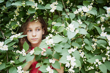 Closeup face of little girl looks out from - paha_l