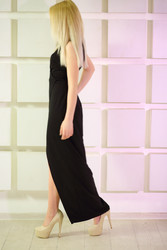 Blonde woman in long dress goes near wall in - paha_l