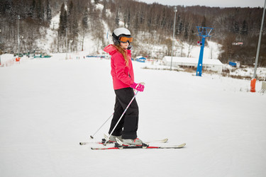 Teenage girl equipped for skiing on snowy slope at - paha_l