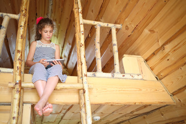 Barefoot girl with tablet computer sitting on the - paha_l
