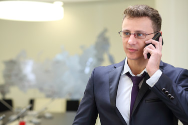 портрет бизнесмена в очках с мобильным телефоном в руке - paha_l