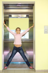 Girl in jeans holding the elevator door and - paha_l