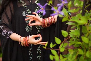 Woman hands in black dress with bracelets - paha_l