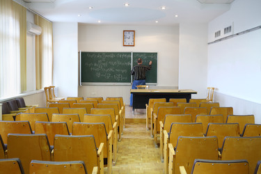 Teacher writes mathematics formulas on blackboard - paha_l