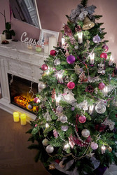 Decorated Christmas firtree near fireplace in room - paha_l