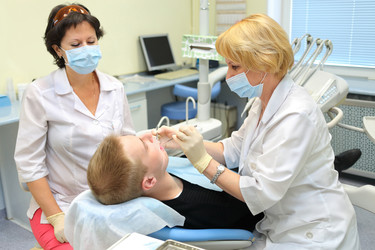 RUSSIA, MOSCOW - AUG 31, 2015: Dentist and nurse making professional - paha_l