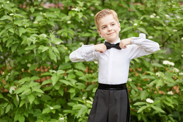 Little boy dressed in dance suit adjusts bow - paha_l
