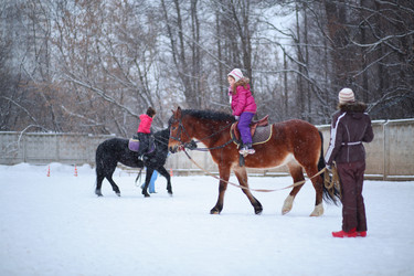 Two girls riding on horses with instructors at the - paha_l