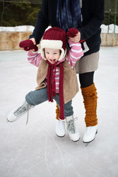 Little girl learning to skate holding hands - paha_l
