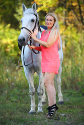 Woman in short pink dress stands near on white - paha_l