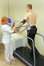RUSSIA, MOSCOW - AUG 31, 2015 : doctor holds ECG man during exercise, - paha_l