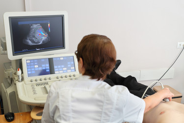 MOSCOW - AUG 31, 2015: Doctor examines patient using ultrasound, in - paha_l