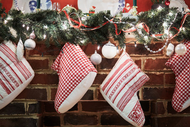 Gift boots hang on mantelshelf decorated to - paha_l