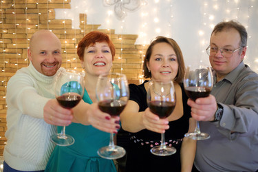 Happy two men and two women held out their glasses - paha_l