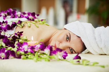 Woman lies on couch among flowers and burning - paha_l