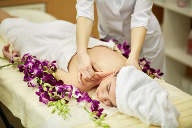 Female massage therapist hands massage shoulders - paha_l