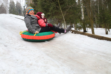 Woman with child rolling hills on a sledge in the - paha_l