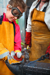 Girl in goggles and yellow apron with hammer - paha_l