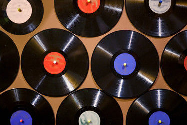 Old dusty damaged vinyl disks pinned to the yellow - paha_l