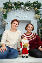 Two women sit on floor with little santa claus in - paha_l