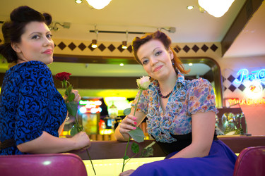 Two beautiful women an bar with roses in hands - paha_l