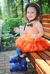 Girl in roller skates sits on bench and smiles at - paha_l