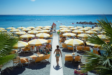 LIGURIA, ITALY - AUG 06, 2016: People on coastline beach. Ligurian - paha_l