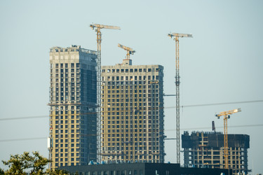 москва, 27 сентября 2025 года, на городских строительных площадках возвышаются многоэтажки с подъемными кранами - AntonSAN
