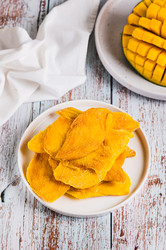 вкусное, сладкое, нарезанное ломтиками манго на тарелке на столе вертикальный вид - Elena Rui