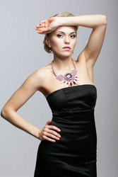 Blonde woman in black dress and necklace - Serg Zastavkin